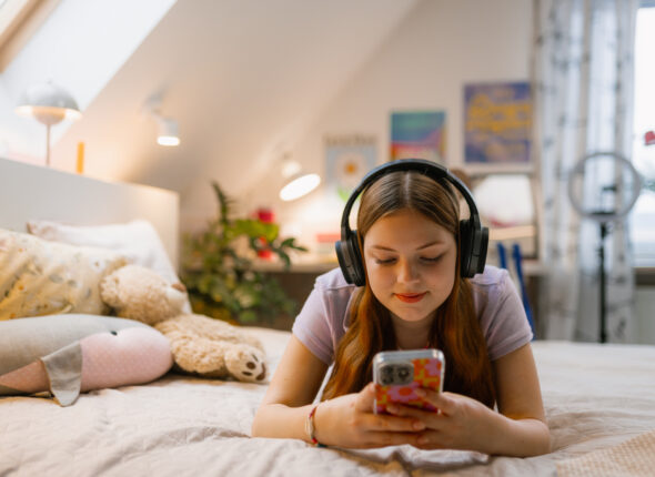 A teenager uses a mobile phone